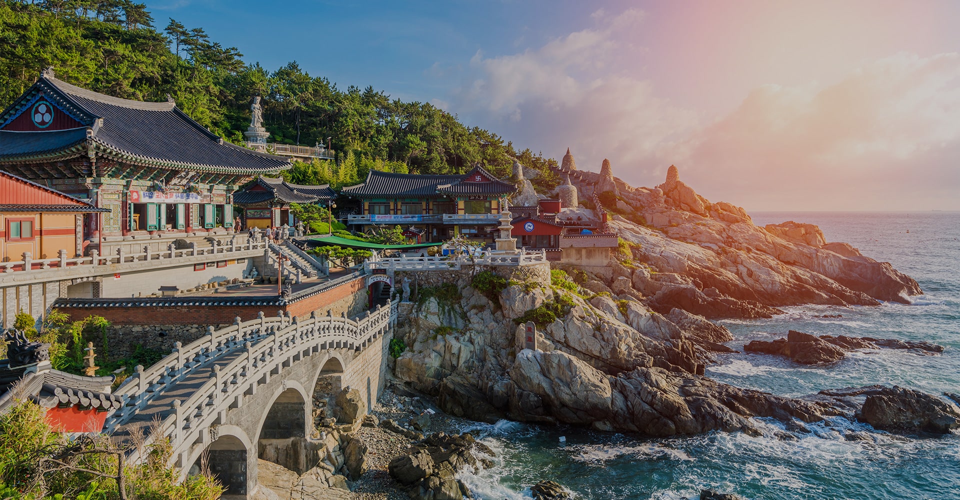 Korean Temples Nestled Along the Rocky Shoreline of an Island, Offering Tranquility by the Vast Ocean.