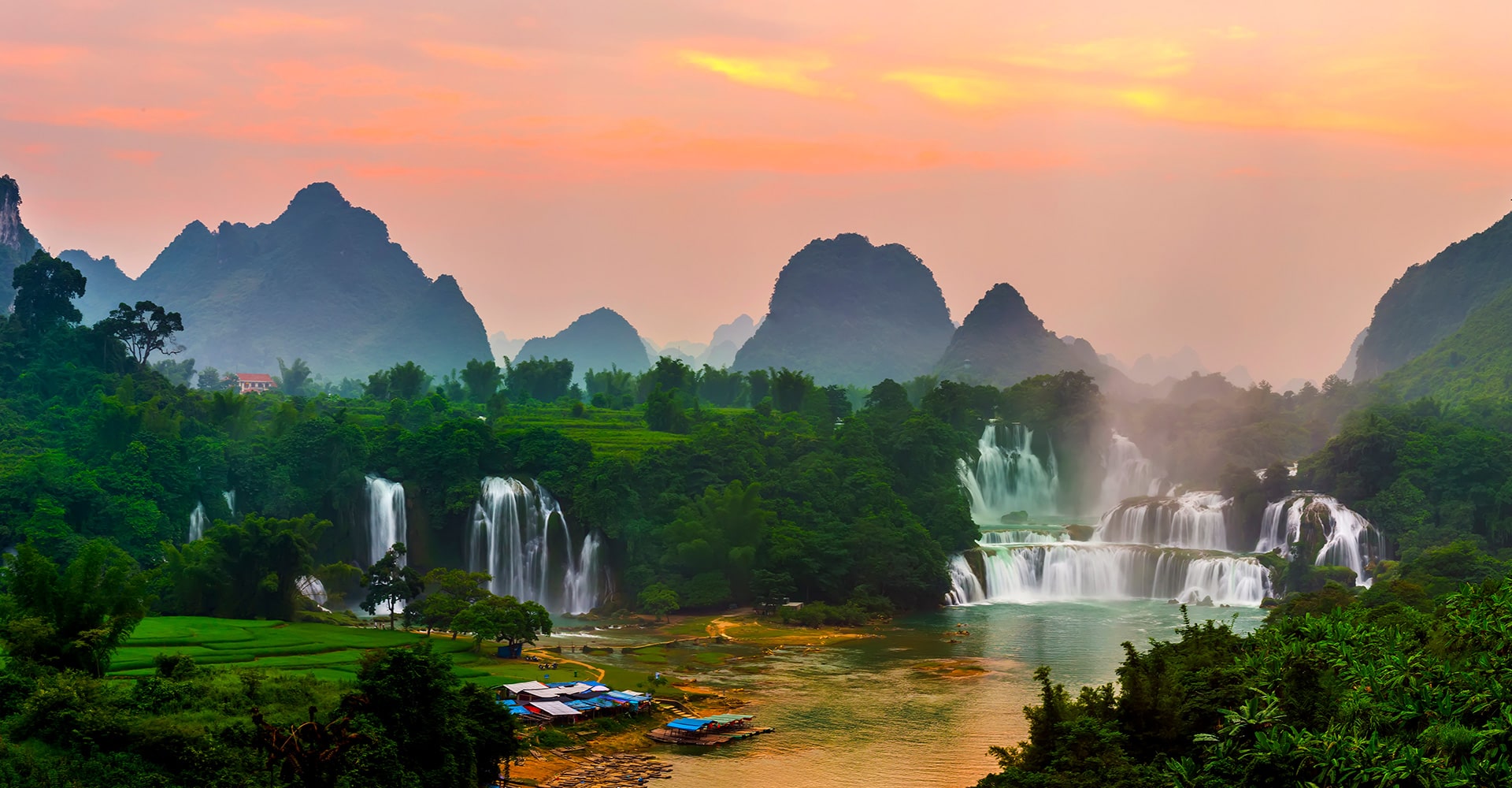 Breathtaking Forests with Cascading Waterfalls and Towering Mountains During a Serene Sunset in Vietnam.