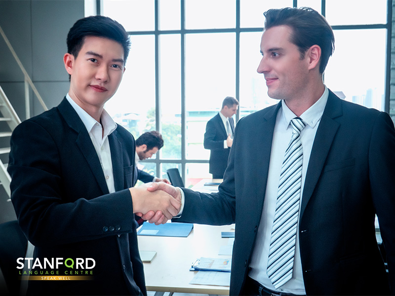 A Chinese and European businessman shaking hand-skillsfuture language courses
